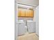 Functional laundry room with washer, dryer, and cabinetry at 17922 E 104Th Pl # D, Commerce City, CO 80022