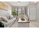 Cozy living room with two couches, neutral decor, and natural light from large windows at 17922 E 104Th Pl # D, Commerce City, CO 80022