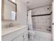 Updated bathroom with white vanity and tub shower with decorative tile at 3363 Oneal Pkwy # 36, Boulder, CO 80301