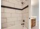 Updated bathroom features marble-look tile surround and bronze fixtures at 3363 Oneal Pkwy # 36, Boulder, CO 80301