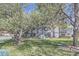 Exterior view of a light blue condo building surrounded by mature trees and well-maintained lawn at 3363 Oneal Pkwy # 36, Boulder, CO 80301