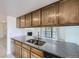 Bright kitchen features modern countertops, stainless steel sink, and wood cabinetry, with views to the living room and fireplace at 3363 Oneal Pkwy # 36, Boulder, CO 80301