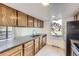 Kitchen featuring wood cabinets, stainless steel appliances, and a view from a window at 3363 Oneal Pkwy # 36, Boulder, CO 80301