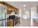 Kitchen with stainless steel appliances, wood cabinetry, and granite countertops at 3363 Oneal Pkwy # 36, Boulder, CO 80301