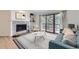 Inviting living room featuring a stone fireplace, stylish decor, and access to balcony at 3363 Oneal Pkwy # 36, Boulder, CO 80301