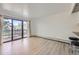 Light-filled living room with sliding glass door to balcony with wooded view at 3363 Oneal Pkwy # 36, Boulder, CO 80301