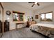 Cozy bedroom with large windows offering scenic views and a ceiling fan at 13954 Pine Country Ln, Conifer, CO 80433