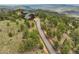Stunning mountain home with a long driveway surrounded by lush greenery at 13954 Pine Country Ln, Conifer, CO 80433