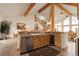 Kitchen with wood cabinets, stainless steel appliances, and an island with bar seating at 13954 Pine Country Ln, Conifer, CO 80433