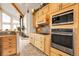 Well-equipped kitchen features custom wood cabinets, stainless steel appliances, and ample counter space at 13954 Pine Country Ln, Conifer, CO 80433