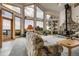 Bright living room boasting incredible views, a stone fireplace, and comfortable seating at 13954 Pine Country Ln, Conifer, CO 80433