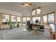 Bright office with large windows framing scenic mountain views and comfortable workspace at 13954 Pine Country Ln, Conifer, CO 80433