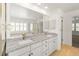 Bright bathroom boasts double sinks, modern fixtures, and separate shower and tub at 8073 S Albion St, Centennial, CO 80122