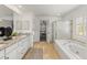 Bright bathroom with double sinks, granite countertops, a soaking tub, and a separate shower at 8073 S Albion St, Centennial, CO 80122