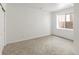 An empty bedroom with plush carpeting, white walls, and a window to let in plenty of light at 8073 S Albion St, Centennial, CO 80122