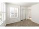 This bedroom has neutral carpet, shuttered windows, and white walls, creating a bright and comfortable space at 8073 S Albion St, Centennial, CO 80122