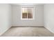Empty bedroom features plush carpeting, white walls, and a window providing natural light at 8073 S Albion St, Centennial, CO 80122