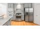 Well-equipped kitchen features stainless steel appliances, gray cabinets, and hardwood floors at 8073 S Albion St, Centennial, CO 80122