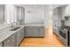 Modern kitchen featuring gray cabinetry, stainless steel appliances, and a breakfast bar overlooking the living area at 8073 S Albion St, Centennial, CO 80122