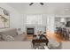 Bright living room with a fireplace, hardwood floors, and an open layout leading to the kitchen at 8073 S Albion St, Centennial, CO 80122