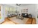 Sun-lit living room showcases hardwood floors, modern decor, and large windows with plantation shutters at 8073 S Albion St, Centennial, CO 80122