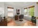 Sunlit office featuring hardwood floors, a traditional desk setup, and three windows with natural light at 8073 S Albion St, Centennial, CO 80122