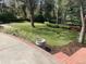 Spacious backyard showcasing a well-manicured lawn, brick patio steps, mature trees, and green landscaping at 3975 S Cherry St, Cherry Hills Village, CO 80113