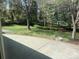 Expansive backyard featuring lush green lawn, mature trees, landscape lighting, and a patio area at 3975 S Cherry St, Cherry Hills Village, CO 80113
