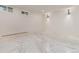 Bright unfinished basement with large windows and stylish sconce lighting at 3975 S Cherry St, Cherry Hills Village, CO 80113
