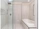 Contemporary bathroom features glass shower, soaking tub, and neutral tile surround at 3975 S Cherry St, Cherry Hills Village, CO 80113