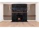 Modern fireplace features a black marble facade and wood shelving accents at 3975 S Cherry St, Cherry Hills Village, CO 80113