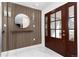 Elegant foyer features a modern mirror, stylish wall accents, and sleek marble floors at 3975 S Cherry St, Cherry Hills Village, CO 80113