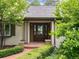 Inviting front entrance with double doors, sidelights, potted plants, and a red brick path at 3975 S Cherry St, Cherry Hills Village, CO 80113