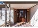 Stylish front door features a glass insert and sidelights, set in a covered entrance with brick accents at 3975 S Cherry St, Cherry Hills Village, CO 80113