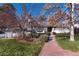 Charming single-story home featuring a brick walkway and mature trees in a well-maintained front yard at 3975 S Cherry St, Cherry Hills Village, CO 80113