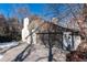 Two-car garage with driveway, white brick siding, dark trim and roof, surrounded by sparse landscaping at 3975 S Cherry St, Cherry Hills Village, CO 80113
