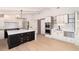 Spacious kitchen featuring a large island, stainless steel appliances, modern lighting, and plenty of cabinet space at 3975 S Cherry St, Cherry Hills Village, CO 80113