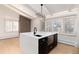 Bright kitchen featuring a large island with sink and stainless steel appliances at 3975 S Cherry St, Cherry Hills Village, CO 80113