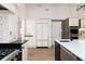 Modern kitchen featuring stainless steel appliances, custom cabinets, and a large island with a sink at 3975 S Cherry St, Cherry Hills Village, CO 80113