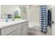 Clean bathroom featuring a sink, shower, and stylish blue striped shower curtain at 16762 Tejon Ln, Broomfield, CO 80023