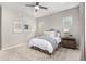 Bedroom featuring a ceiling fan, large windows, neutral decor, and a stylish headboard at 16762 Tejon Ln, Broomfield, CO 80023