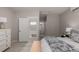 Well-lit bedroom with a cozy atmosphere, featuring a hallway and bathroom view at 16762 Tejon Ln, Broomfield, CO 80023