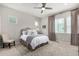 Cozy bedroom with a ceiling fan, large windows, neutral color scheme, and a stylish headboard at 16762 Tejon Ln, Broomfield, CO 80023