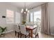 Cozy dining room with a stylish chandelier, large windows, and access to the outdoors at 16762 Tejon Ln, Broomfield, CO 80023
