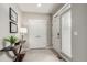 Bright entryway with white door, double coat closet, table and modern lamp at 16762 Tejon Ln, Broomfield, CO 80023