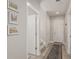 Hallway with an open door that reveals carpeted stairs and three framed wall pictures at 16762 Tejon Ln, Broomfield, CO 80023