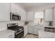 Bright kitchen features white cabinets, stainless steel appliances, and light countertops at 16762 Tejon Ln, Broomfield, CO 80023