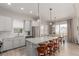 Open kitchen with a large center island, stainless appliances, and adjacent dining area at 16762 Tejon Ln, Broomfield, CO 80023
