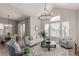 Bright living room featuring high ceilings, large windows, neutral decor and an elegant chandelier at 16762 Tejon Ln, Broomfield, CO 80023
