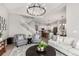 Spacious living room with an open floor plan, staircase, modern lighting, and neutral decor at 16762 Tejon Ln, Broomfield, CO 80023